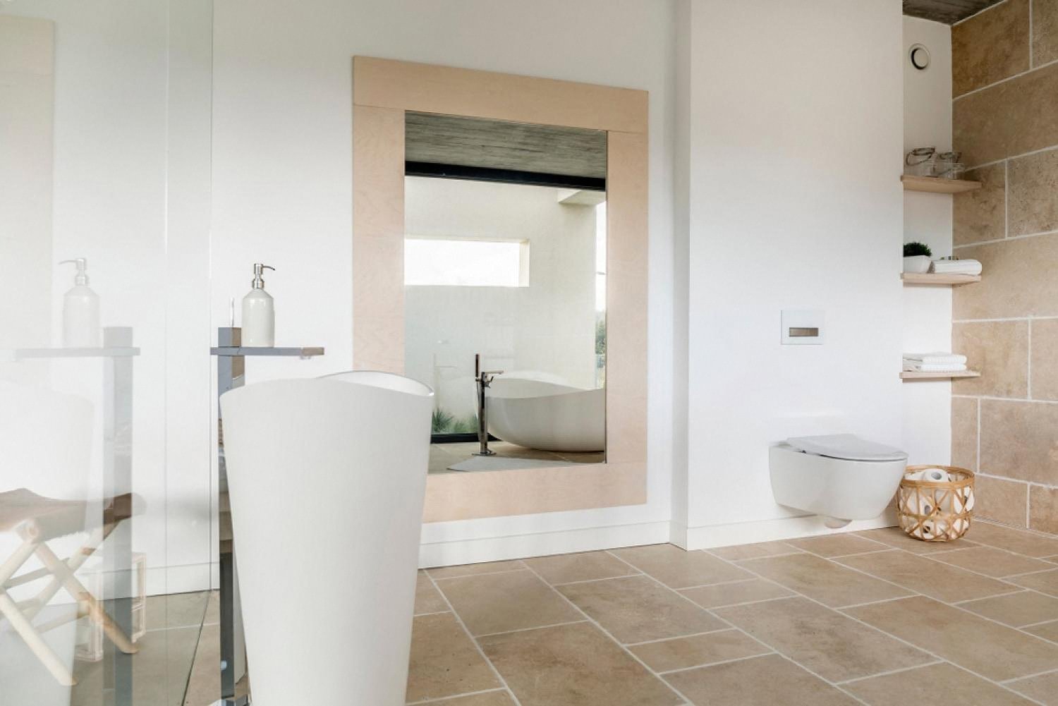 Bathroom with a large framed wall mirror serving as a disguised entrance to a safe room